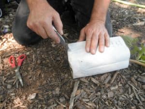 2. Insert knife or scissors at the base of the bag.