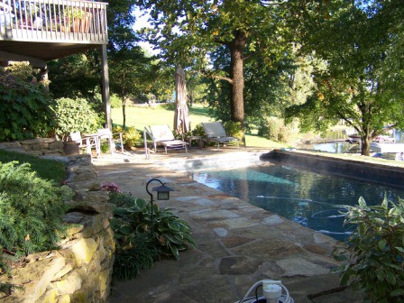 Poolside plantings and patio give a relaxing natural setting for swimming.